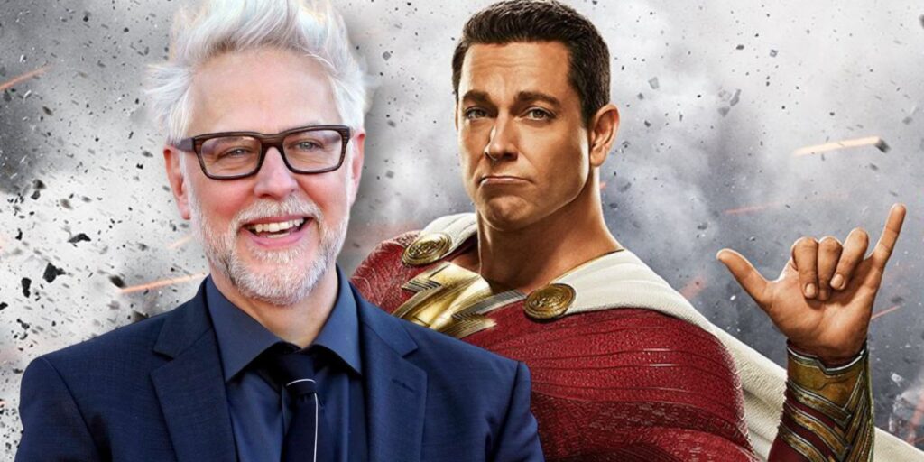 James Gunn in front on Shazam (Zachary Levi), who is holding up a Shaka hand signal