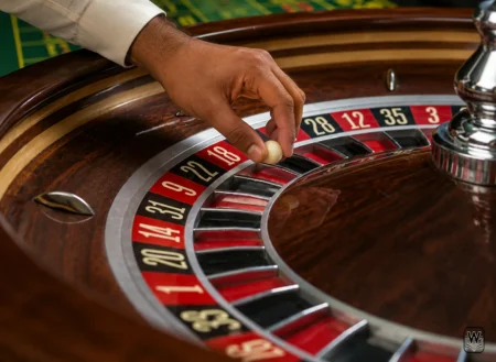 roulette wheel and croupier hand with white ball